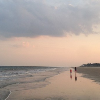 a group of people on a beach near a body of water