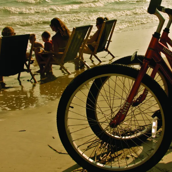 a group of people sitting at a beach